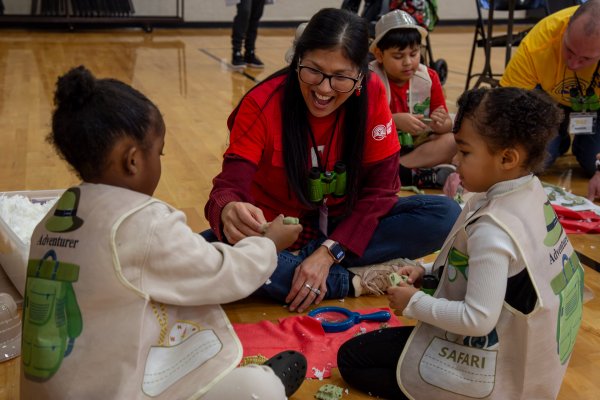 a teacher engages with two young girls