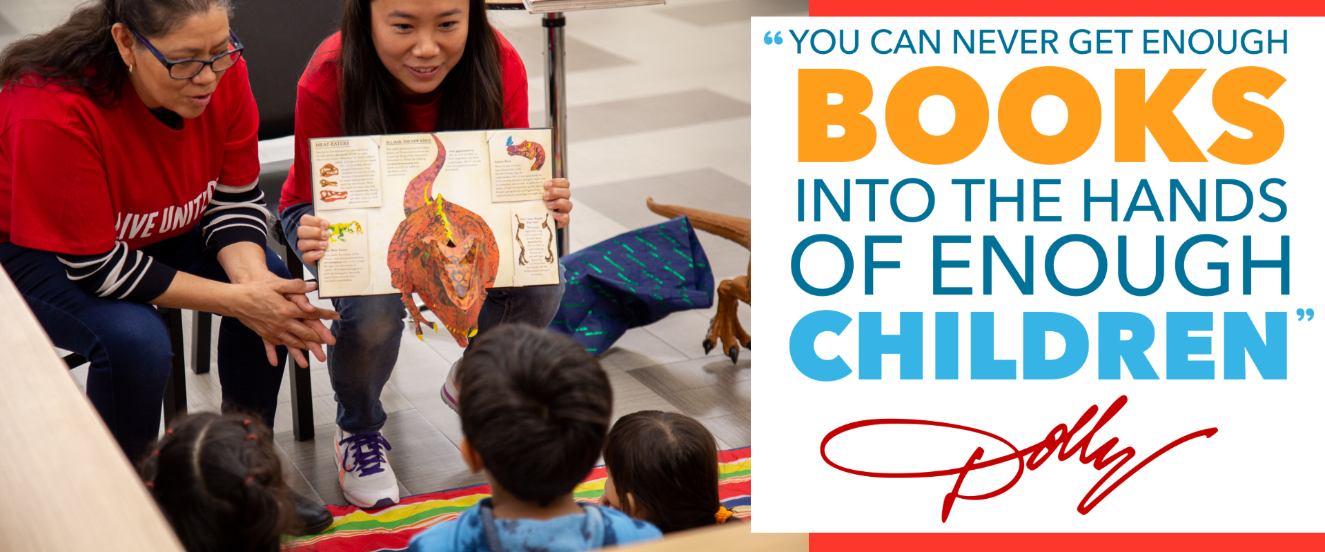 A photo of two women showing a pop up book of a dinosaur to two children.