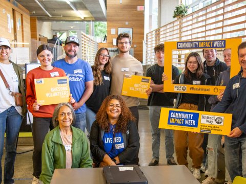 A large group of folks smile for the camera