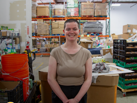 a woman smiles in a warehouse